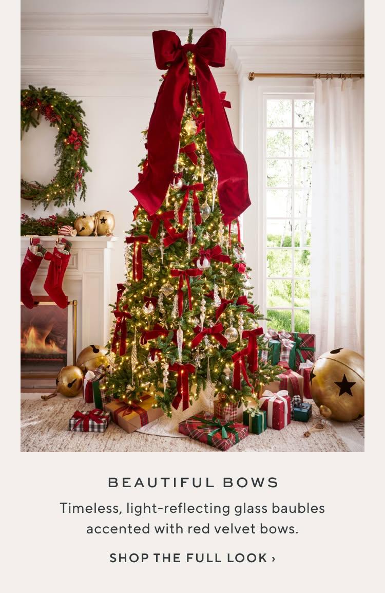 Beautiful Bows: timeless, light-reflecting glass baubles accented with red velvet bows. Shop the full look.